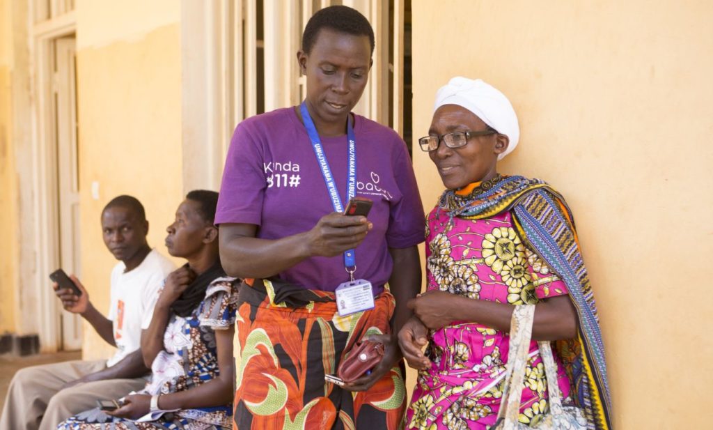 A Babyl support worker helping a patient in Rwanda